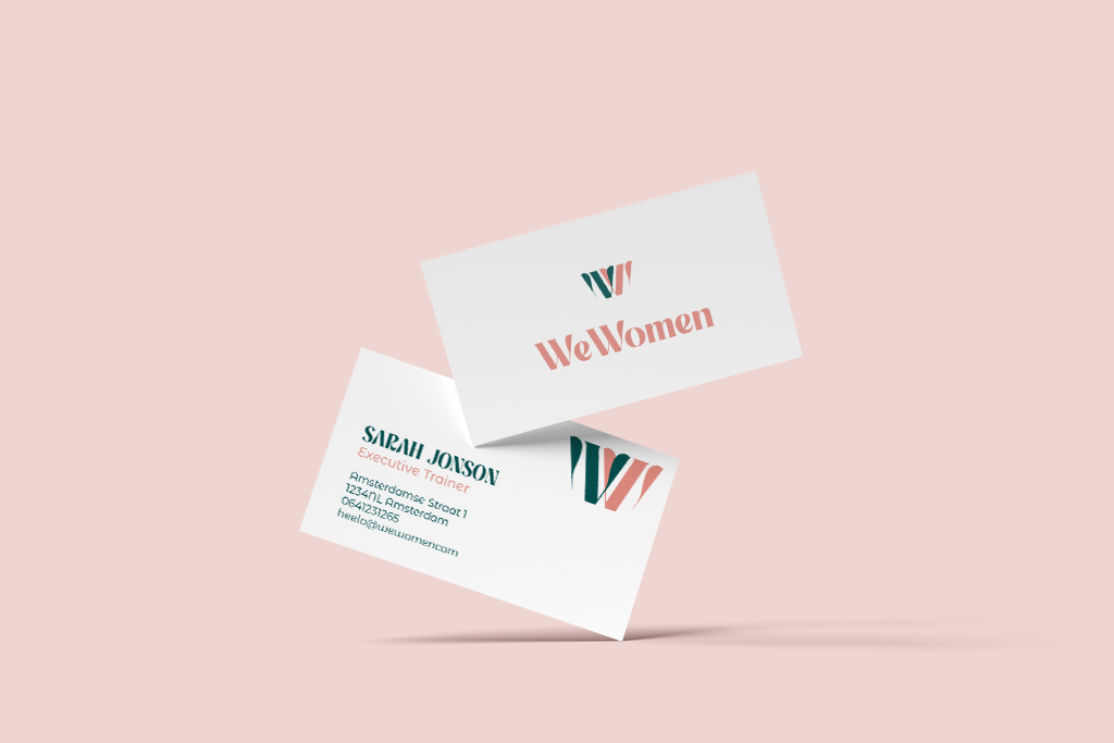 WeWomen business card mock-up showing the logo and visual identity