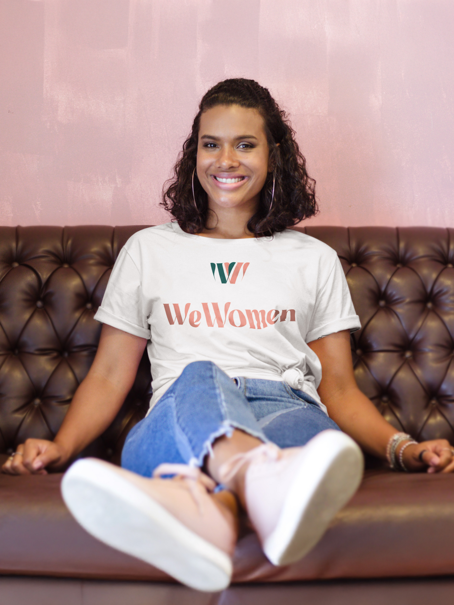 Woman wearing a WeWomen branded T-shirt showing the visual identity in use